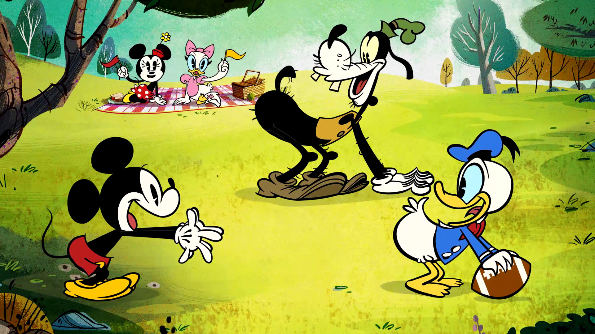 Mickey, Donald, and Goofy from Mickey Mouse Shorts are playing football in a field while Daisy and Minnie sit on a picnic blanket waving colored flags.