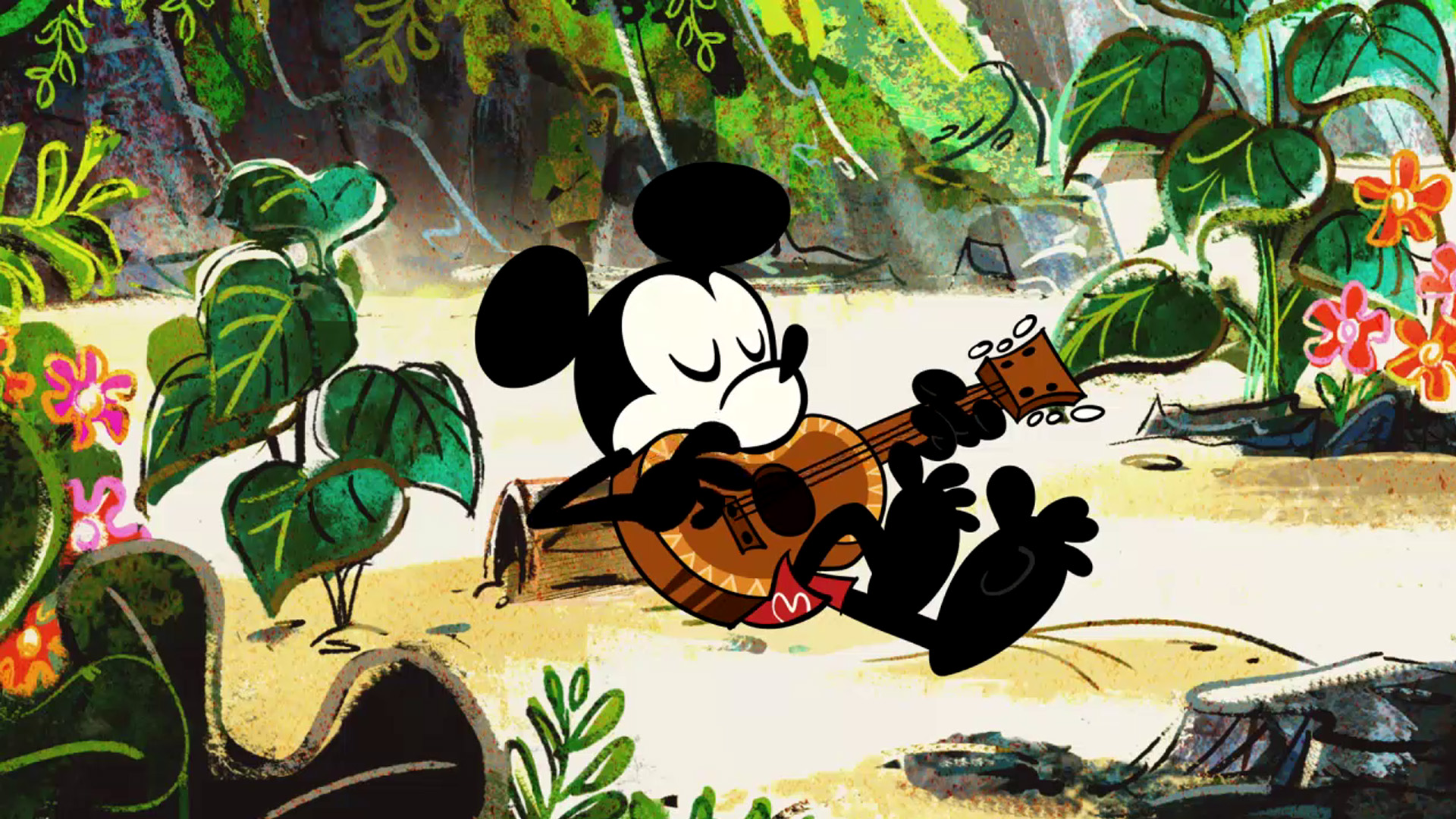 Mickey from Mickey Shorts sits on a log on a tropical beach in a bathing suit as he strums on a guitar.