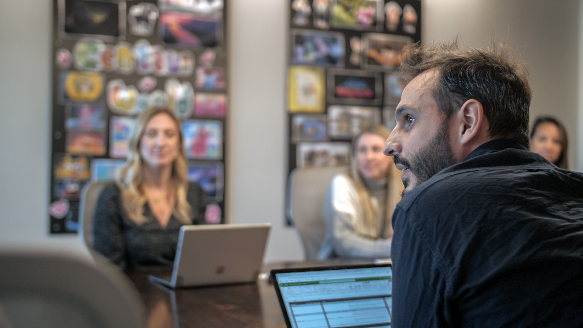 An executive from Mercury Filmworks talks in a meeting as the background is blurred.