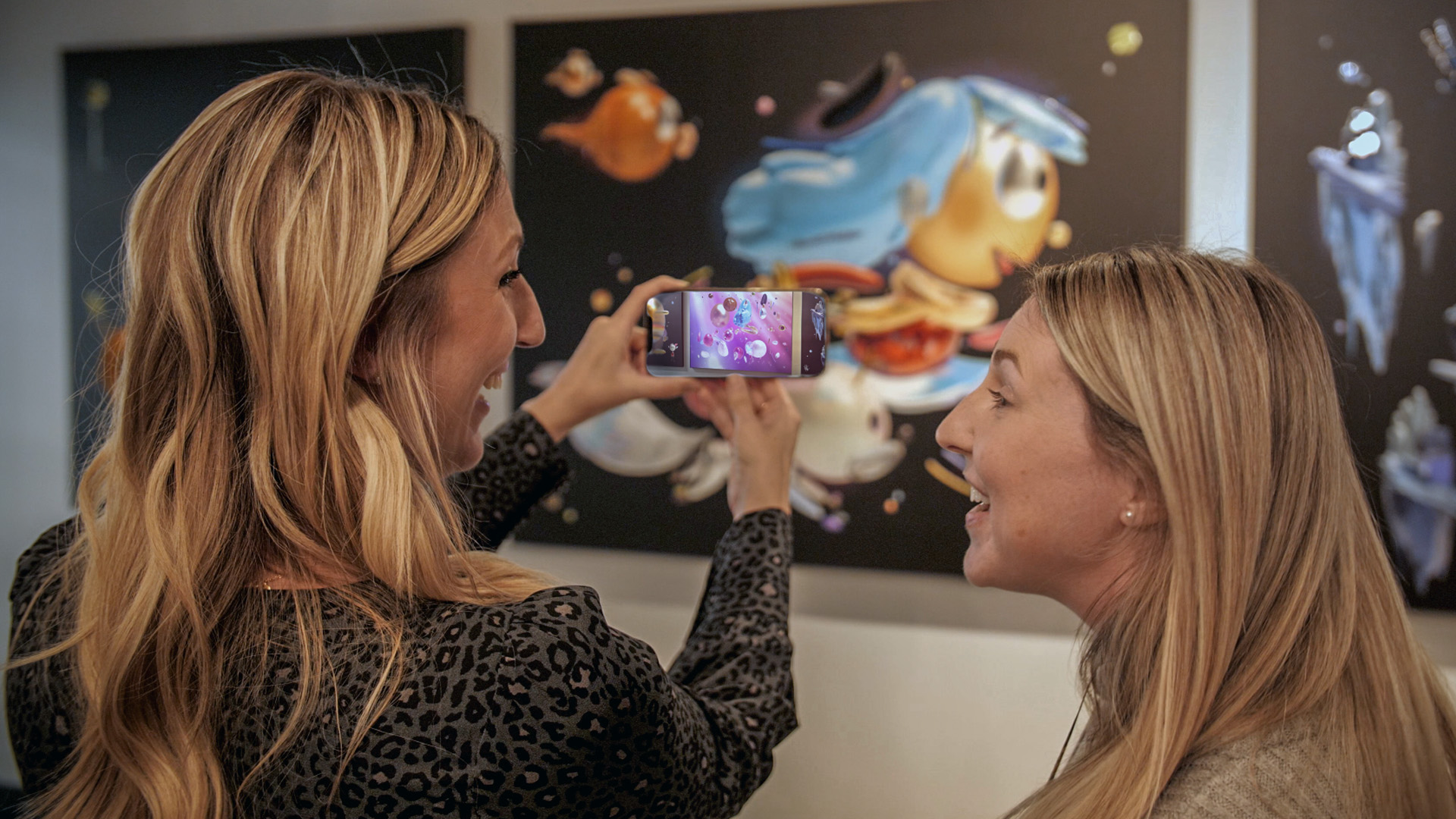 Two Line Producers from Mercury Filmworks watch an augmented video of Hilda art in our studio.