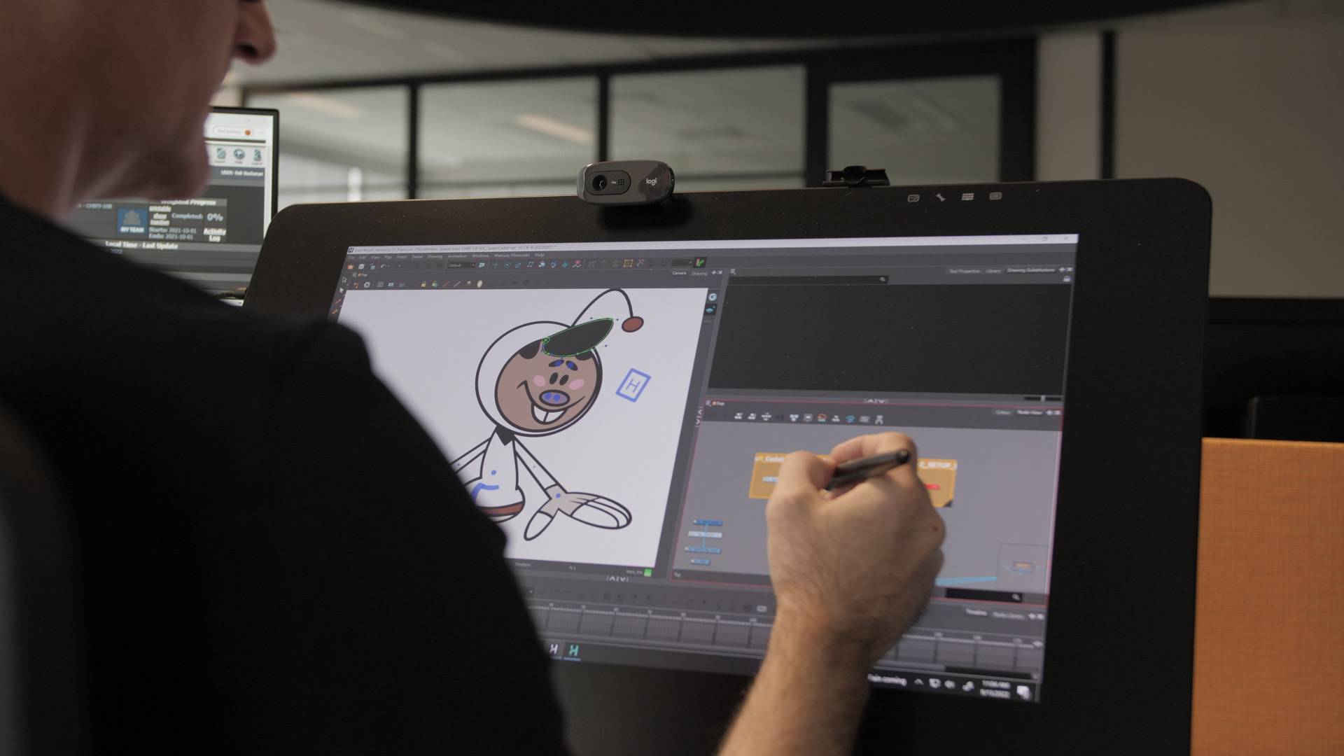An animator draws on a cintiq that shows Mercury Filmworks training tool Chip Johnson.